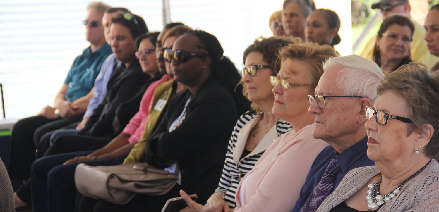 Audience members listen to the keynote speaker during the DBS Ribbon Cutting Ceremony.